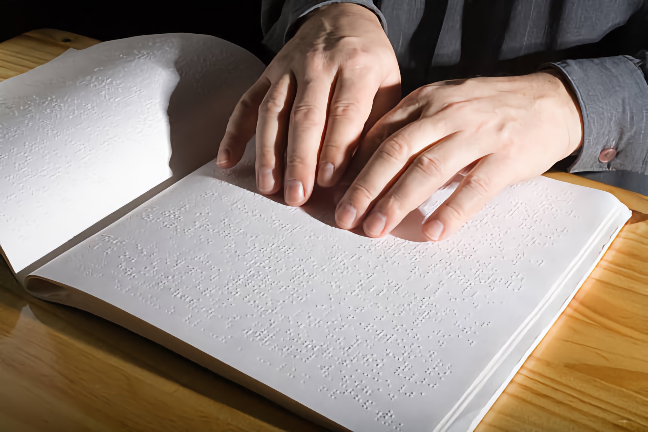 Adult hands reading Braille