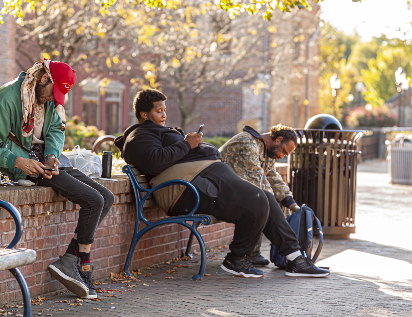 People living on the street using mobile phones to access information