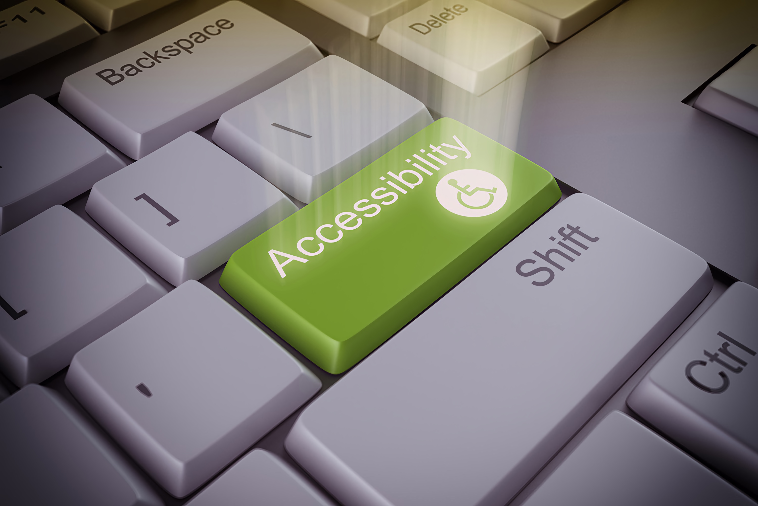 Close-up of a computer keyboard with a highlighted green 'Accessibility' key, imagined as the gateway to creating inclusive digital experiences