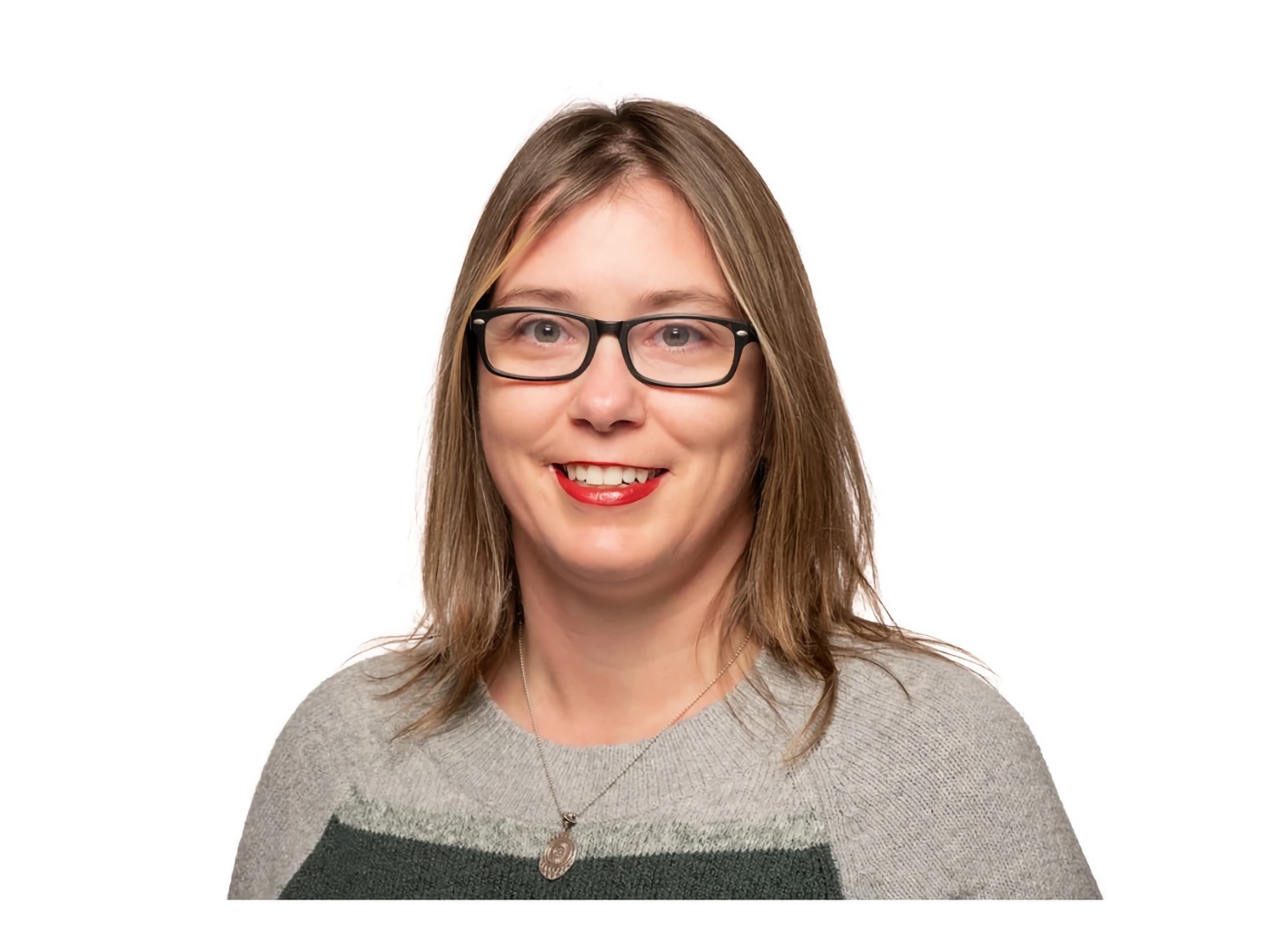 Early Adult Woman with straight light-brown hair and glasses smiles toward the camera