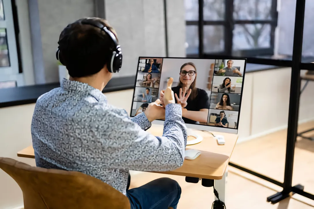 Man communicating via (ASL) American Sign Language in a virtual meeting
